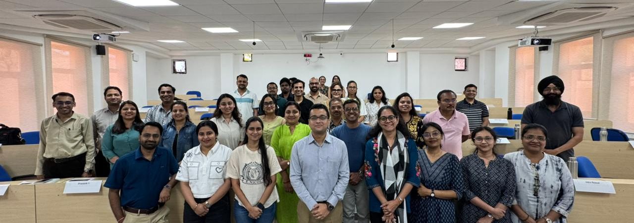 Faculty members participating in a Faculty Development Program at IIM Indore discussing experiential learning strategies.
