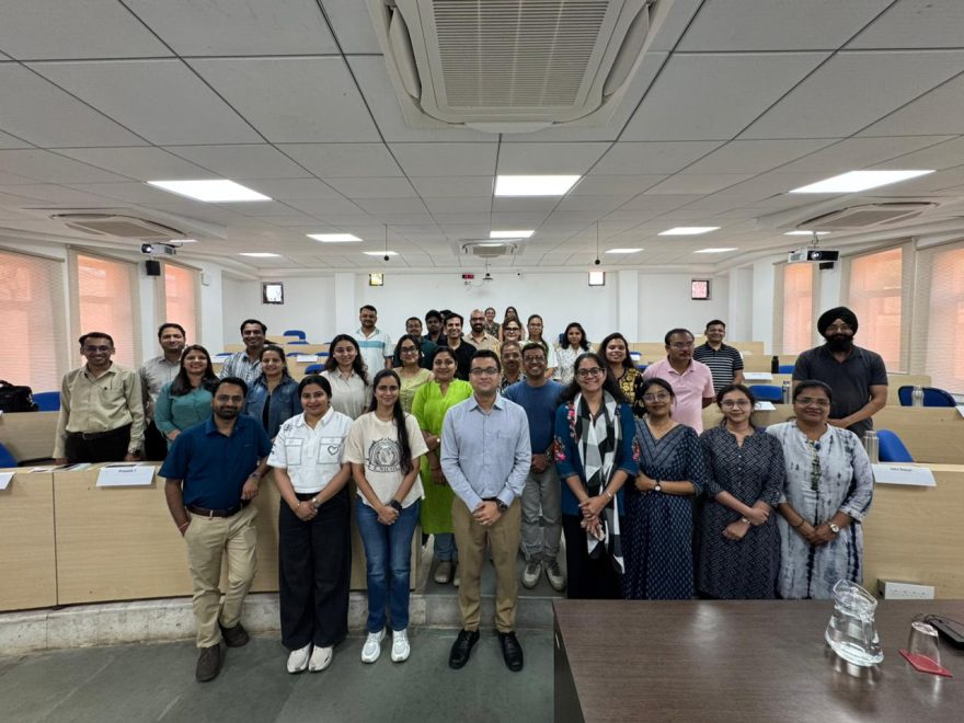 Faculty members participating in a Faculty Development Program at IIM Indore discussing experiential learning strategies.